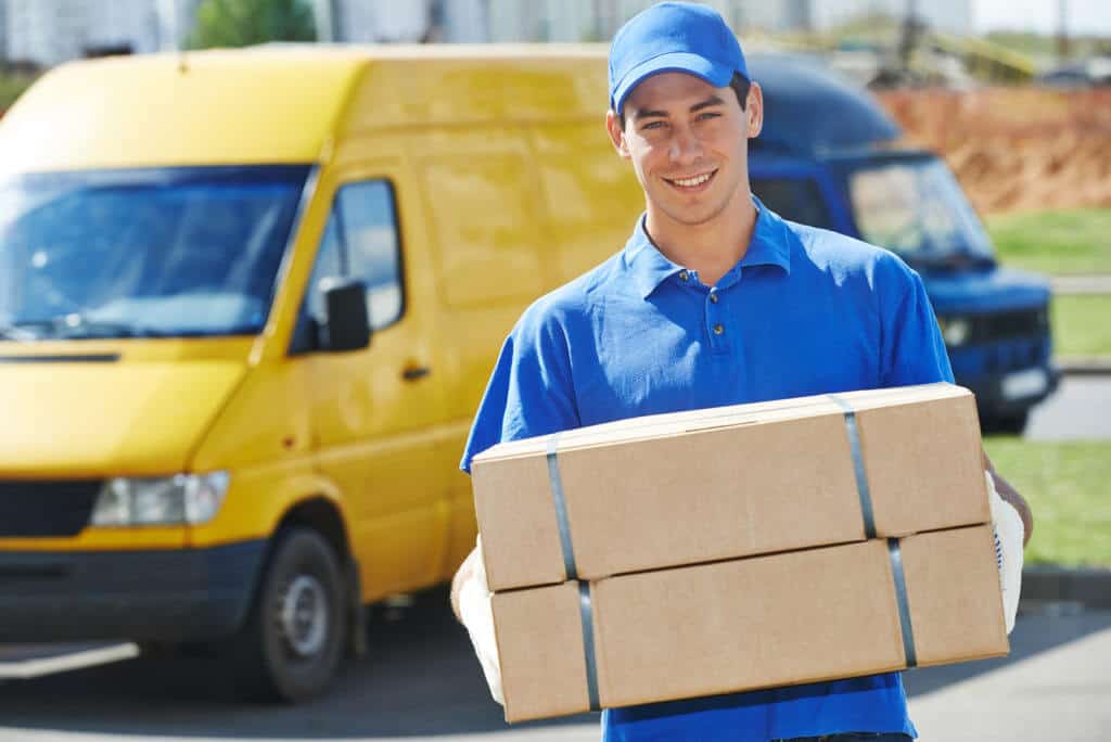 male courier delivering two packages with a smile