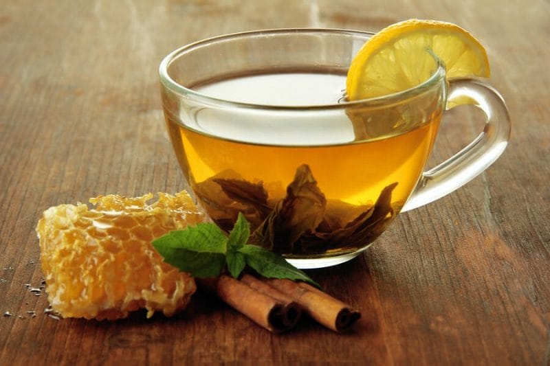 A Cup of Tea with Honey, Cinnamon, Lemon and Basil Leaf