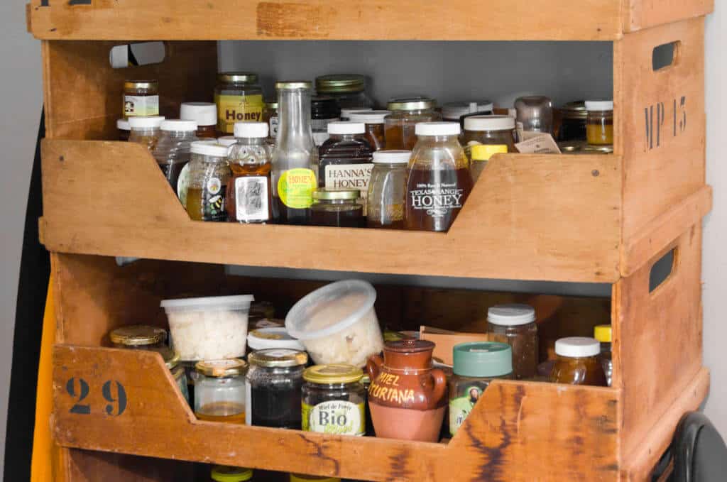 Bottles of Honey Stored on Shelves 