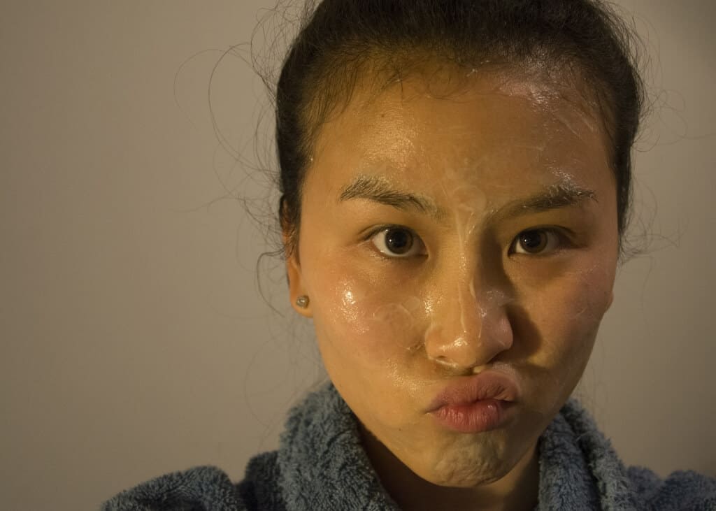 A Woman Applying a Manuka Honey Face Mask 