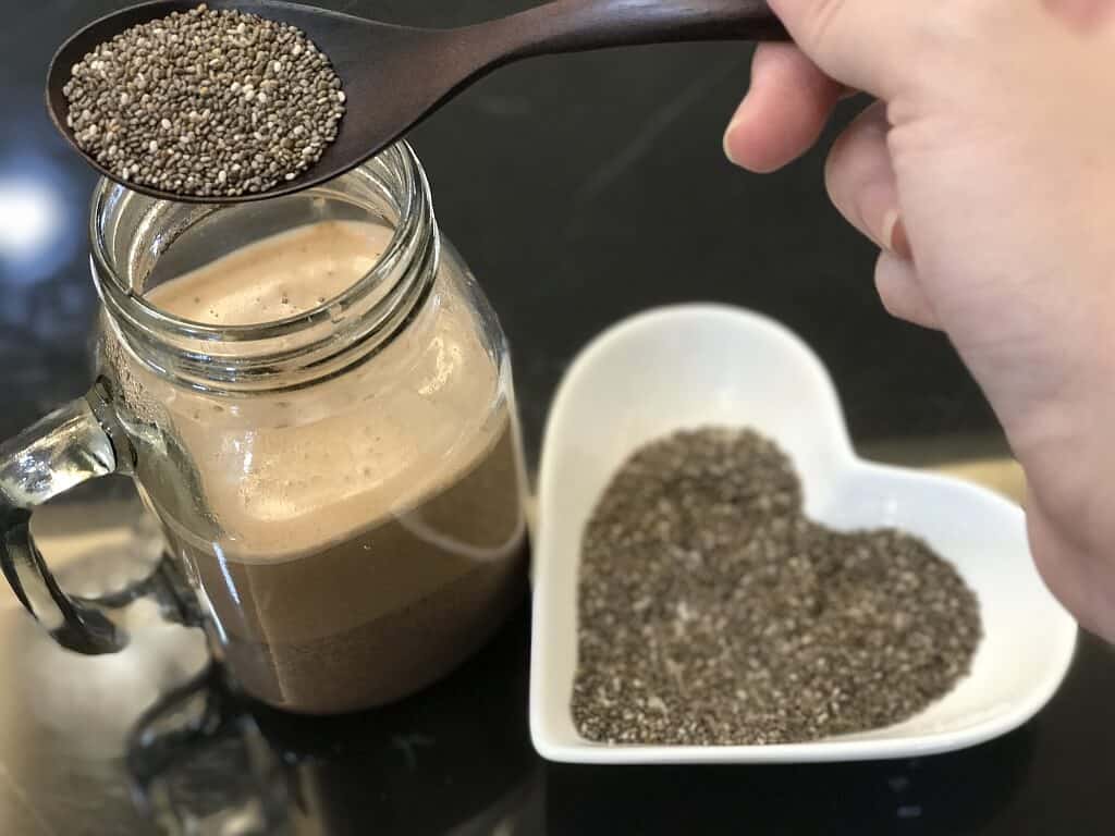 Adding a Spoonful of Chia Seeds to a Drink
