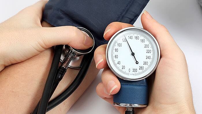 Taking a person's blood pressure with a blood pressure monitor