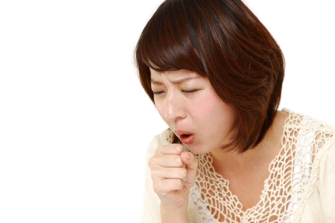 Young asian woman coughing