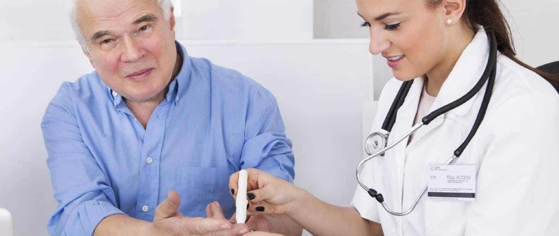 Male patient with a female doctor taking a diabetes glucose prick test 