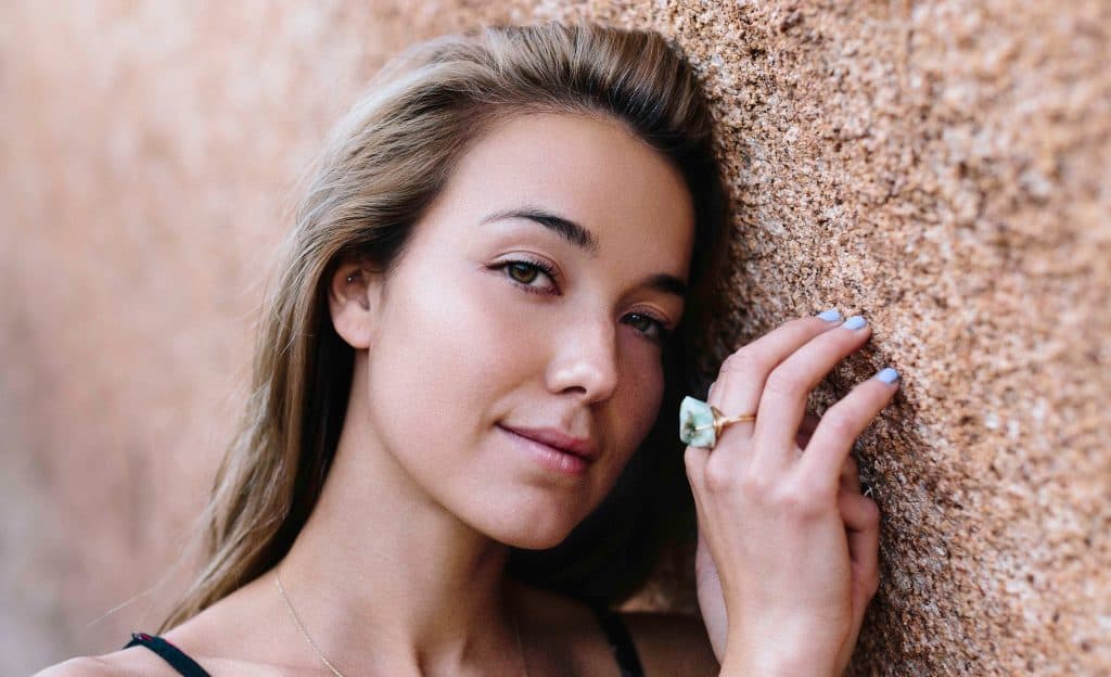 Young girl posing against the wall