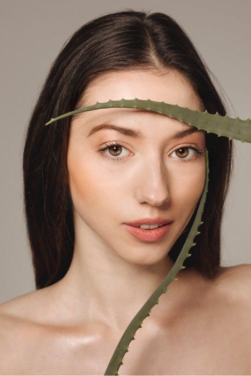 young woman posing with aloe vera 