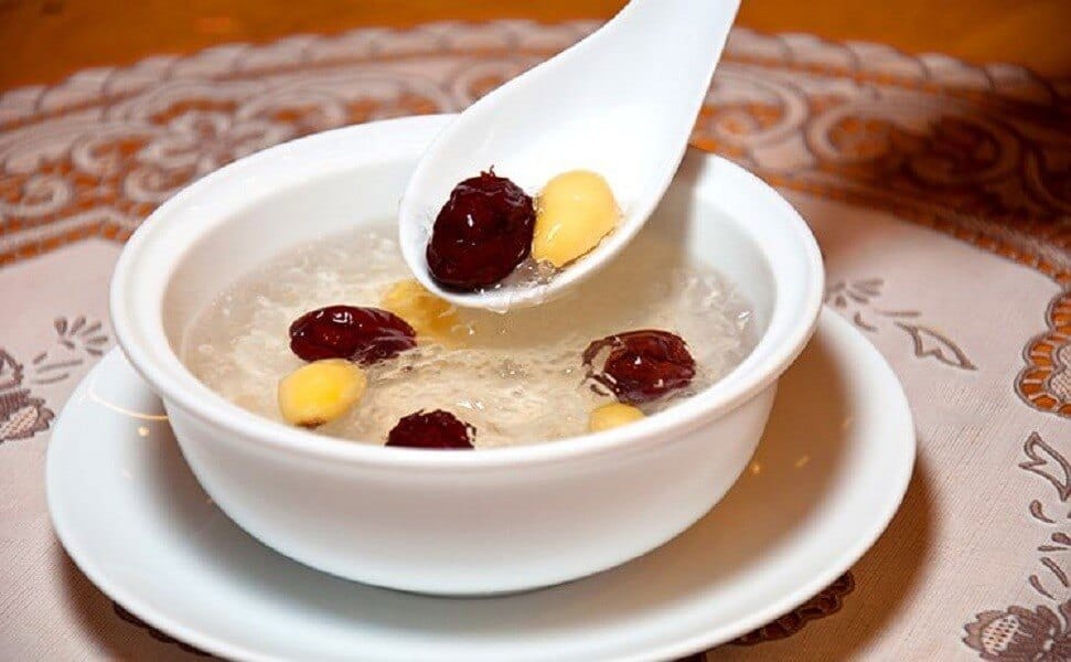 a bowl of bird's nest soup with gingko nuts and red dates 