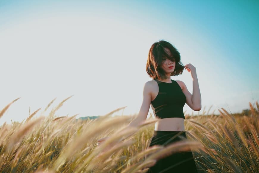 young asian girl posing in a field of lalang 