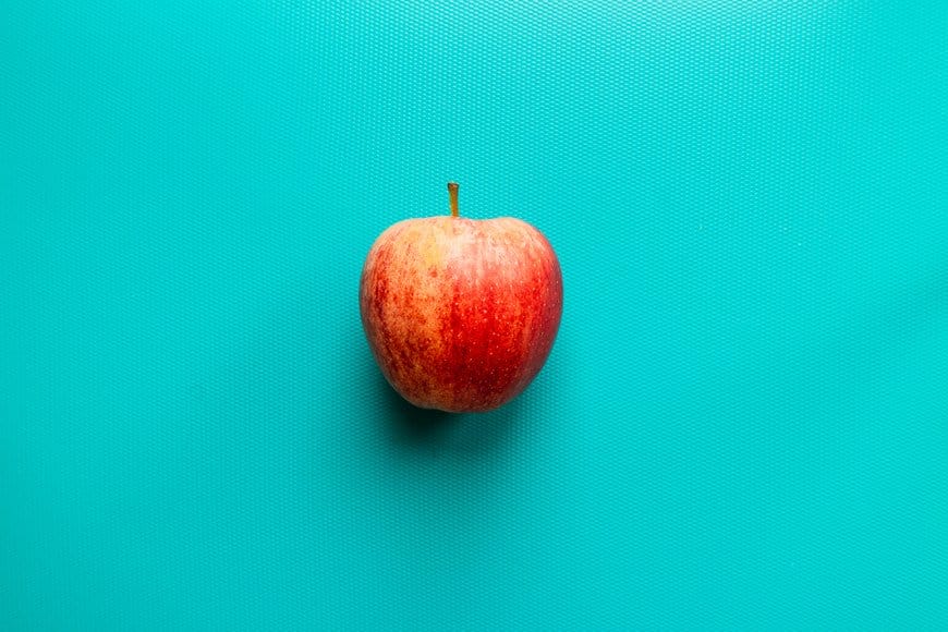 apple on a teal tablemat
